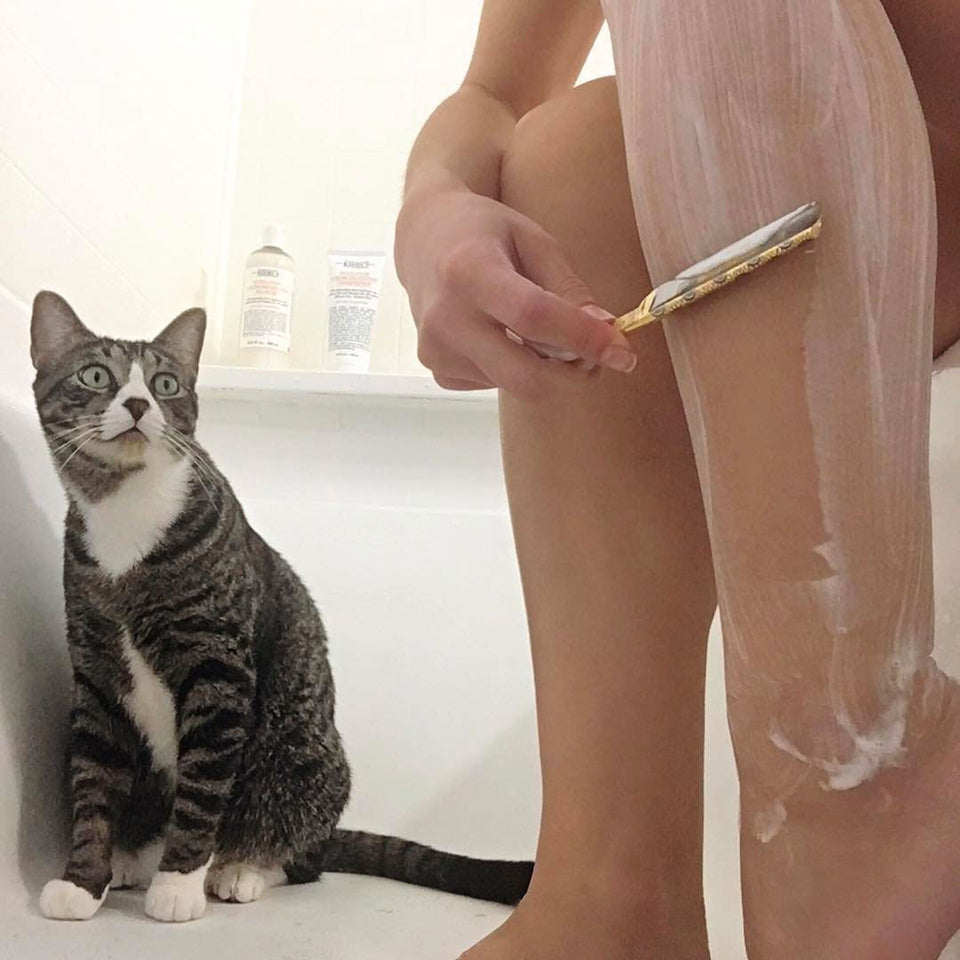 Tomi shaving her legs using straight razor and shaving soap.